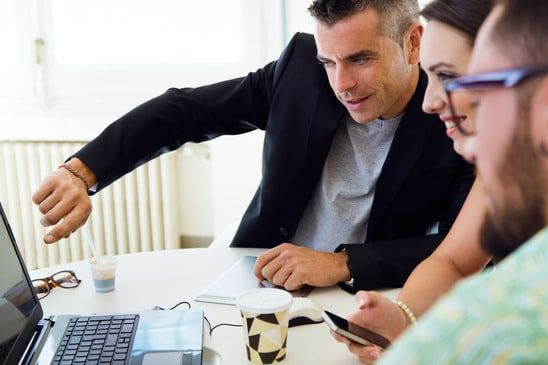 Portrait of casual executives working together at a meeting with laptop. - image licensed from Photodune